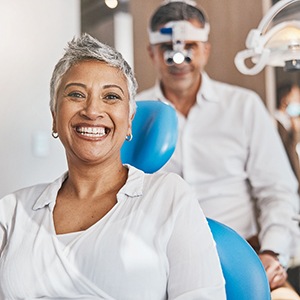 Woman smiling while sitting in treatment chair